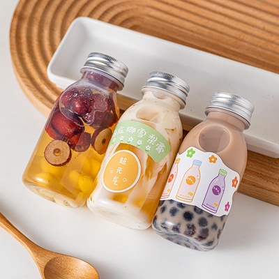 Botellas de jugo de plástico redondas cuadradas a prueba de fugas con tapas