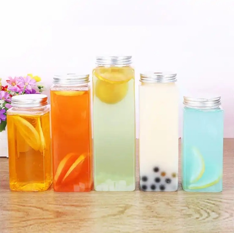 Botellas de té de leche aisladas redondas cuadradas con manija y tornillo de 0,5 kg en la tapa